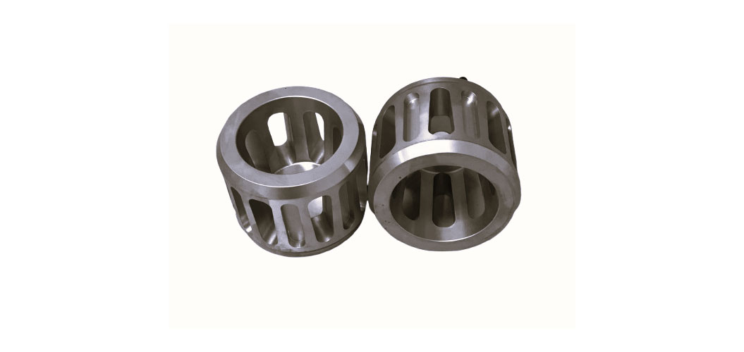 Zwei silberne, zylindrische Metallteile mit Schlitzen auf cremefarbenem Hintergrund.
